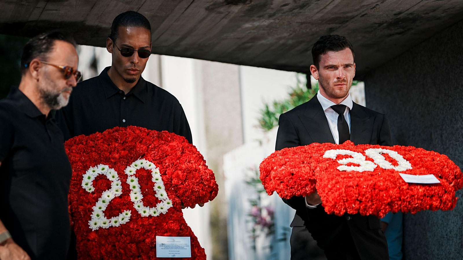Virgil van Dijk and Andy Robertson carry flowers at the funeral of Diogo Jota and Andre Silva