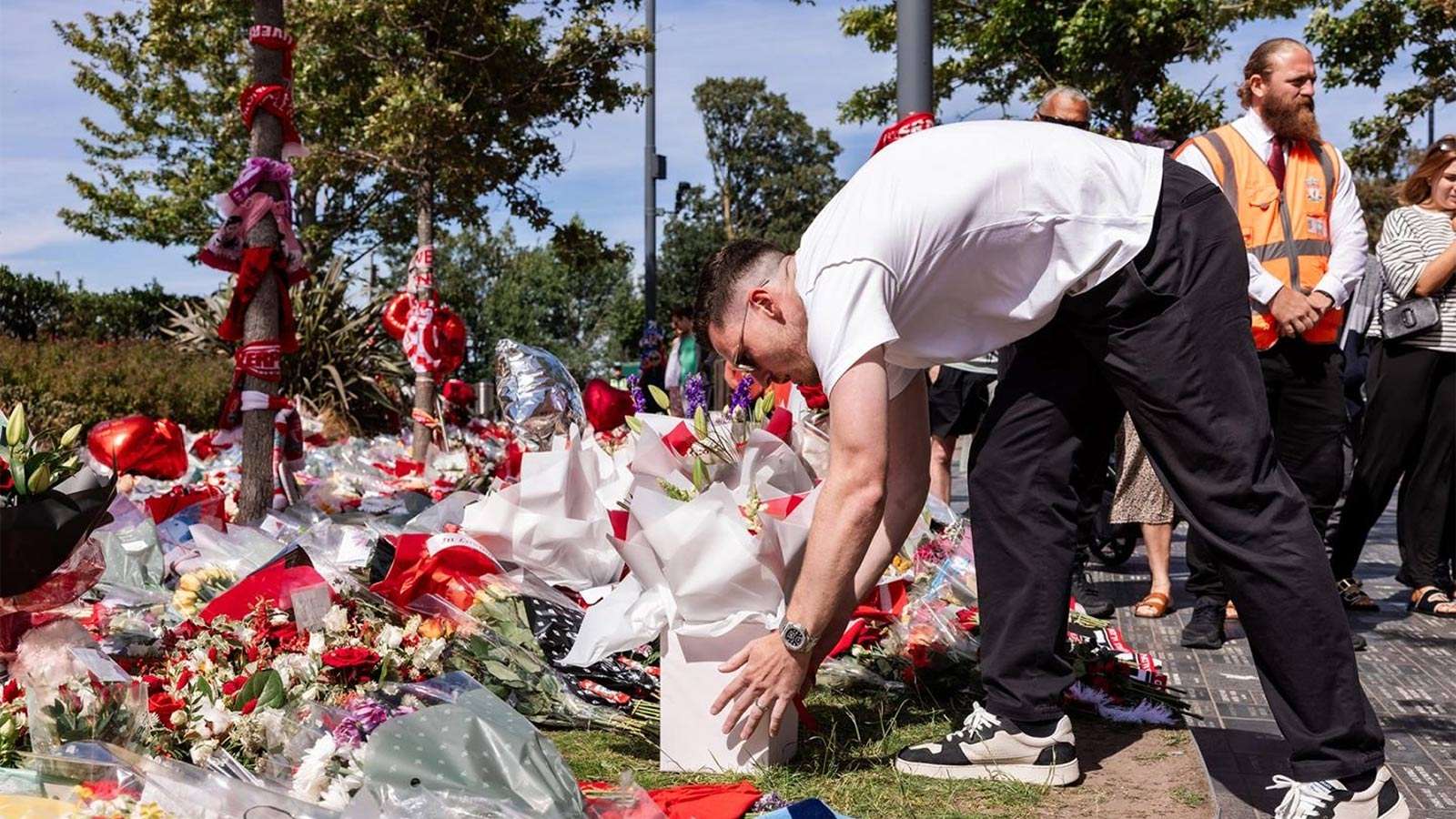 Andy Robertson lays flowers at the Diogo Jota memorial outside Anfield