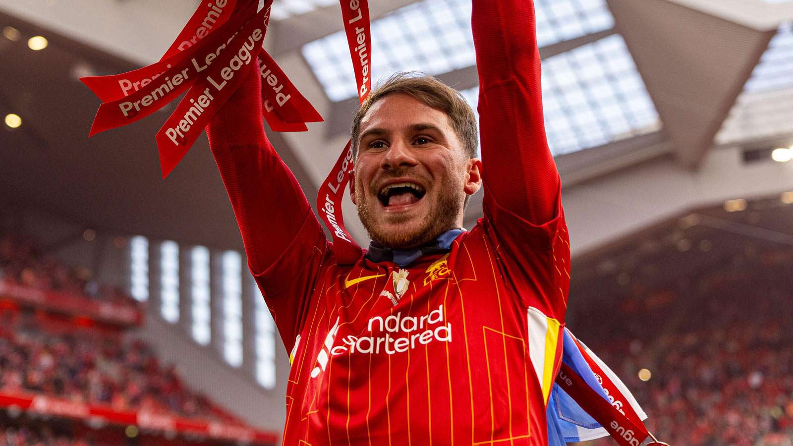Alex Mac Allister lifts the Premier League trophy